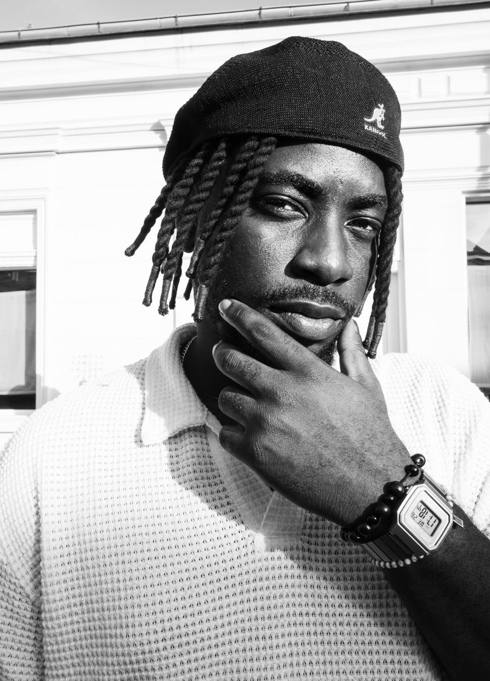 Black and white portrait of DJ Papi in a Kangol beanie