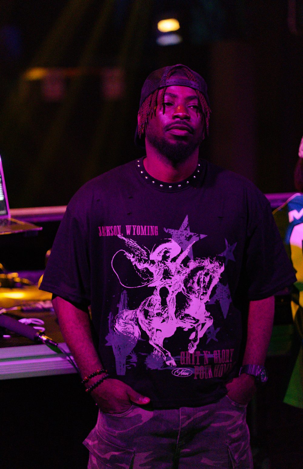 DJ Papi standing at the booth in purple light